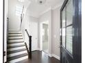 Inviting entryway featuring a staircase, hardwood floors, neutral walls, and a stylish front door at 164 Blakemore Dr, Smyrna, GA 30080