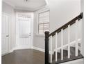 Bright entryway features hardwood floors, white trim and staircase with contrasting railing and stairs at 164 Blakemore Dr, Smyrna, GA 30080