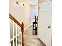 Inviting foyer featuring wood-look floors and staircase, leading to the home's main living areas at 2691 Pointcrest Way, Grayson, GA 30017