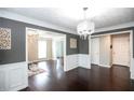 Hardwood floored dining room featuring elegant white wainscoting and large doorways at 620 River Mist Dr, Jonesboro, GA 30238