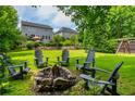 Large backyard featuring a fire pit, Adirondack chairs, and play set perfect for outdoor gatherings at 1282 Kendrick Ne Rd, Brookhaven, GA 30319