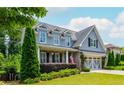Charming two-story home featuring a well-manicured lawn, beautiful landscaping and a gray accent garage at 1282 Kendrick Ne Rd, Brookhaven, GA 30319