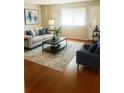 Bright living room featuring a comfortable sofa, chair, and stylish decor at 5581 Marbut Rd, Lithonia, GA 30058
