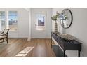 Bright foyer featuring wood floors, a console table, and views of the neighborhood at 1313 Pj East Rd, Covington, GA 30014