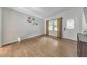 Inviting room with hardwood floors, white door with patterned glass, and lots of natural light at 222 Bishop Ne Dr, Marietta, GA 30060