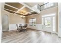 Elegant dining room featuring a decorative ceiling, wainscoting, and wood-look floors at 6298 Gothards Ln, Douglasville, GA 30134
