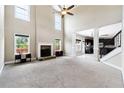 Bright living room with fireplace, high ceilings, carpet floors, and abundant natural light at 6298 Gothards Ln, Douglasville, GA 30134