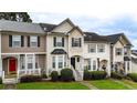Charming townhome with manicured lawn, bay window, black shutters, and welcoming entrance at 88 Timber Ridge Dr, Cartersville, GA 30121