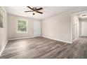 Inviting living room showcasing stylish gray wood-look flooring, a ceiling fan, and a bright, airy atmosphere at 114 Howell Sw Dr, Atlanta, GA 30331