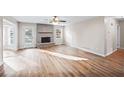 Open-concept living room with a stone fireplace and an exit to the backyard at 1403 W Prospect Dr, Lawrenceville, GA 30043