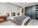 Cozy bedroom featuring a comfortable bed, stylish throw pillows, a wooden side table, and ample closet space at 2479 Peachtree Ne Rd # 201, Atlanta, GA 30305