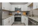 Modern kitchen features stainless steel appliances, white cabinetry, granite countertops, and ample natural light at 2479 Peachtree Ne Rd # 201, Atlanta, GA 30305