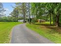 View of the properties driveway, lawn, and various outbuildings at 639 Hall Station Rd, Kingston, GA 30145