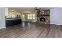 Open-concept living space featuring a stone fireplace and updated kitchen with stainless steel appliances at 216 Hickory Way, Canton, GA 30115