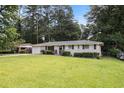 Charming single-story brick home with a well-manicured front lawn and mature trees in a quiet neighborhood at 2292 Country Club Sw Ln, Atlanta, GA 30311