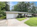 Charming single-story brick home with a well-manicured front lawn and mature trees in a quiet neighborhood at 2292 Country Club Sw Ln, Atlanta, GA 30311