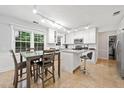 Eat-in kitchen with a center island, stainless steel appliances, and tile flooring at 3123 Westbrook Trce, Lawrenceville, GA 30044