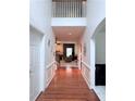 View of the foyer featuring hardwood floors, white walls, and a glimpse into the living area at 3439 Tupelo Trail, Auburn, GA 30011