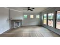 Spacious living room with a fireplace and multiple windows at 5444 Miravista Way, Hoschton, GA 30548
