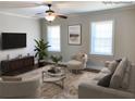 Cozy staged living room with neutral tones, recessed lighting, and hardwood flooring at 2367 Cascade Rd # B7, Atlanta, GA 30311