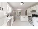 Bright kitchen with stainless steel appliances, white cabinets, and island with quartz countertops at 4252 Keheley Lake Dr, Marietta, GA 30066