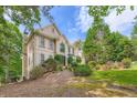 This elegant home is set in a serene landscape with lush greenery and mature trees at 3314 Eagle Watch Dr, Woodstock, GA 30189