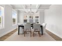 Elegant dining room featuring coffered ceilings, modern chandelier, and plenty of natural light at 4114 Valleyview Ct, Mcdonough, GA 30252