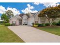 Charming two-story home with a well-manicured lawn, three-car garage, and inviting curb appeal at 9634 Coastal Pointe Dr, Villa Rica, GA 30180