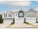 Newly built townhomes featuring varied exterior finishes and attached garages at 2686 Ne Almand Ne Ln, Conyers, GA 30013