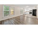 Inviting living room with hardwood floors, connecting seamlessly to the modern, white kitchen at 10545 Virginia Pine Ln, Alpharetta, GA 30022