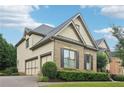 Beautiful home featuring a three car garage and professionally landscaped exterior at 2452 Stone Manor Ne Dr, Buford, GA 30519