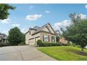 This home includes three-car garage and an elongated driveway at 2452 Stone Manor Ne Dr, Buford, GA 30519