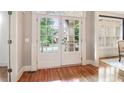 Bright foyer with hardwood floors and double doors with window panes at 2452 Stone Manor Ne Dr, Buford, GA 30519