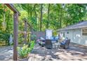 Lovely backyard deck with cozy seating arrangements and lush greenery, offering a serene outdoor living space at 6077 Lake Lanier Heights Rd, Buford, GA 30518