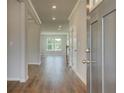 Inviting foyer with wood floors and a view into the living area at 612 Gratton Ln, Mcdonough, GA 30253