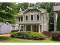 Inviting two-story home with a charming front porch and manicured landscaping, showcasing classic architectural details at 127 Oak Ln, Decatur, GA 30030