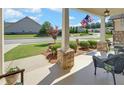 Relaxing front porch featuring comfortable seating and views of the manicured front yard and peaceful neighborhood at 1758 Auburn Ridge Way, Dacula, GA 30019