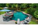 Backyard pool area with a hot tub, diving board, lounge chairs, and privacy fence at 340 Helens Manor Dr, Lawrenceville, GA 30045