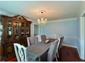Elegant dining room with a chandelier, china cabinet, and seating for six at 810 Doe Hill Ln, Roswell, GA 30075