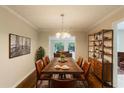 Dining room with seating for 8, modern lighting, hardwood floors, and artful decor at 1282 Shiloh Trail E, Kennesaw, GA 30144