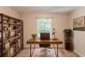 Cozy home office featuring a rustic desk, bookshelf, and large window at 1282 Shiloh Trail E, Kennesaw, GA 30144