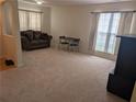 Bright living room with neutral carpet, natural light, and comfortable furnishings at 2234 Oakland Springs Dr, Snellville, GA 30039