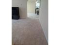 Open-concept living space with neutral carpet flows into the dining area; furniture in the shot at 2234 Oakland Springs Dr, Snellville, GA 30039