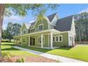 Beautiful home with a covered porch, lush lawn, and attractive landscaping at 529 Claude Scott Rd, Canton, GA 30115