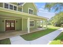 Close-up of a charming porch with white columns, double front doors, and well-maintained lawn at 529 Claude Scott Rd, Canton, GA 30115