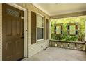 Close-up of the front porch featuring a classic wooden door, side window, and brick facade at 1104 Victory Sw Dr, Atlanta, GA 30310