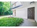 Apartment entrance with front door, green bushes, and exterior walkway at 1445 Monroe Ne Dr # C32, Atlanta, GA 30324