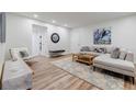Well-lit living room with light gray sofa, wood floors, and modern decor at 1445 Monroe Ne Dr # C32, Atlanta, GA 30324