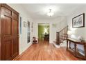Bright entryway with hardwood floors, stairs and a view into the dining room at 300 Stone Mill Trl, Atlanta, GA 30328
