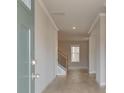 Bright entryway showcasing wood-look flooring, neutral paint, and views of the staircase and living area at 616 Gratton Ln, Mcdonough, GA 30253